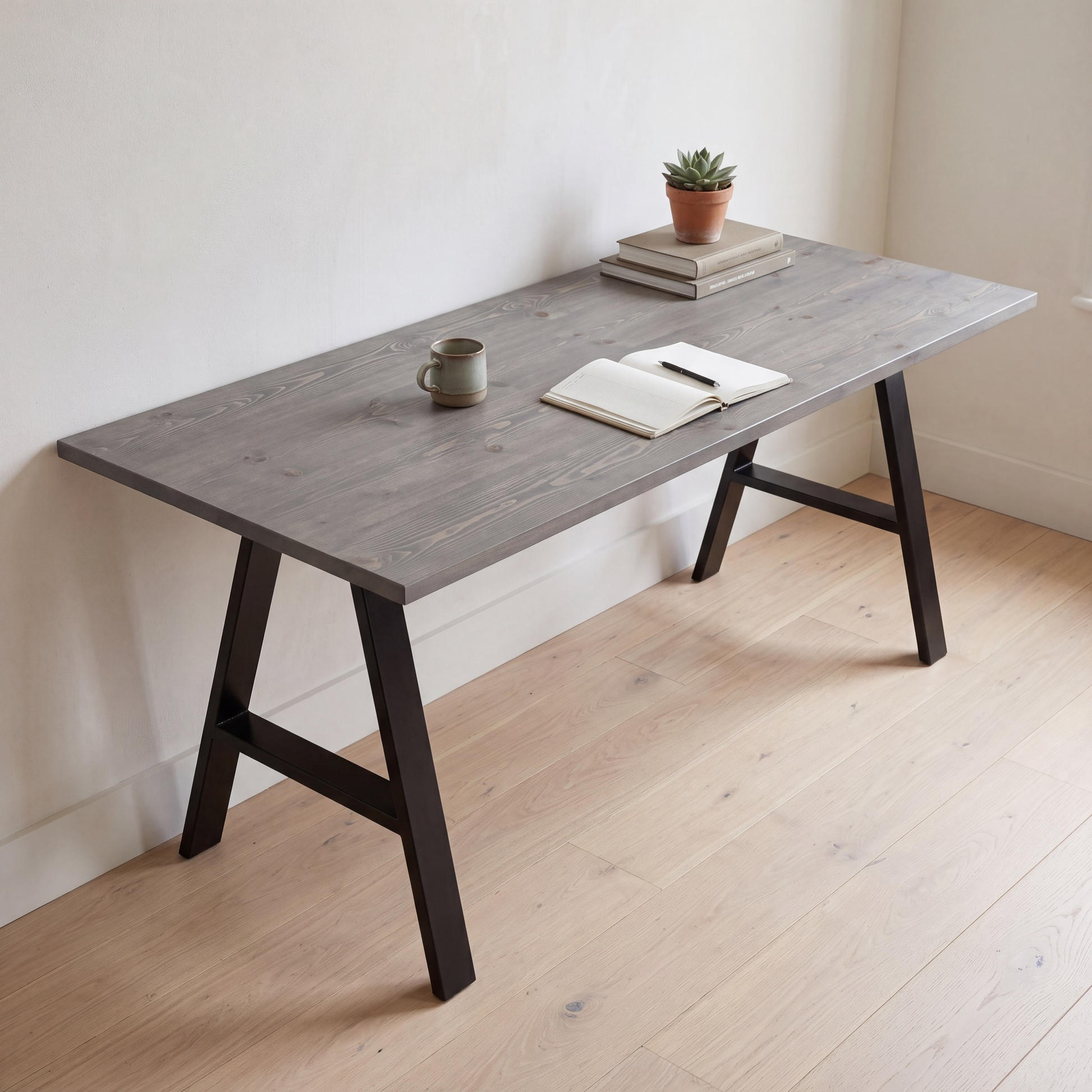Grove Solid Wood Desk, Graphite finish, black A-frame legs, lifestyle