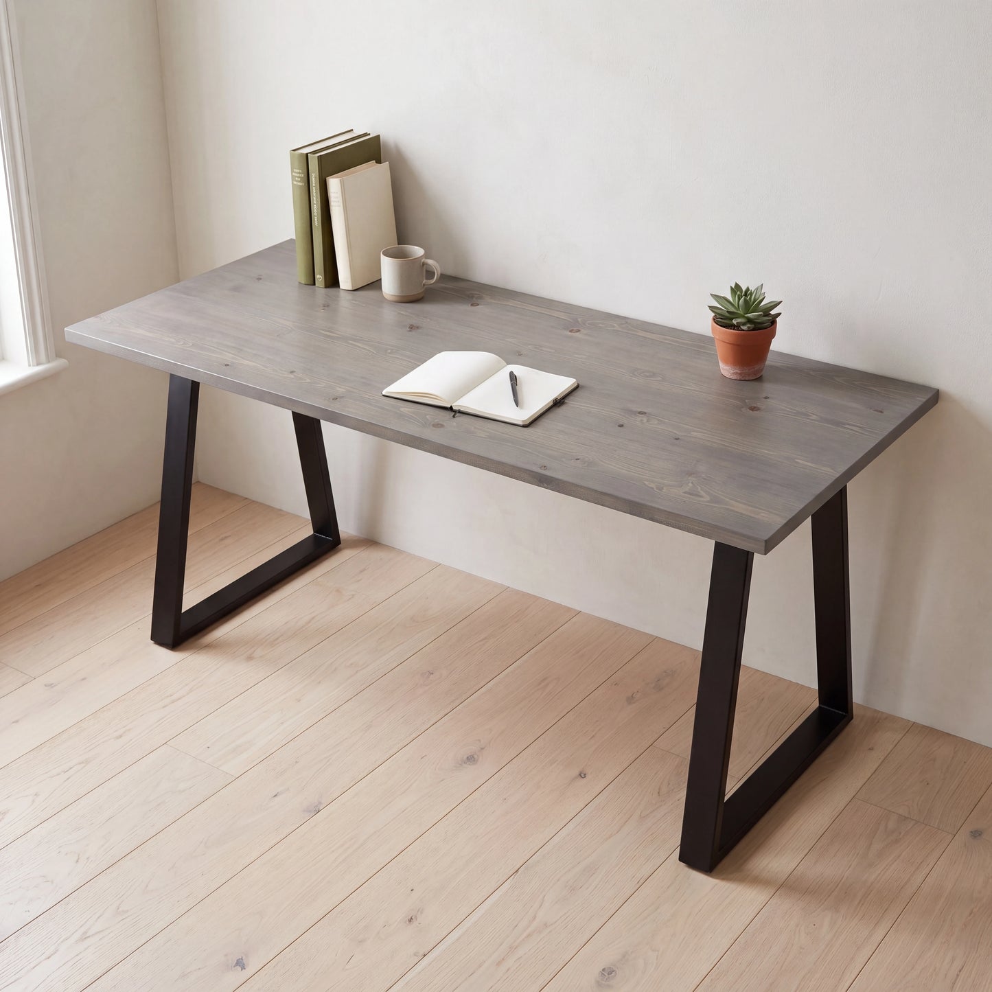 Grove Solid Wood Desk, Graphite finish, black trapezium legs, lifestyle