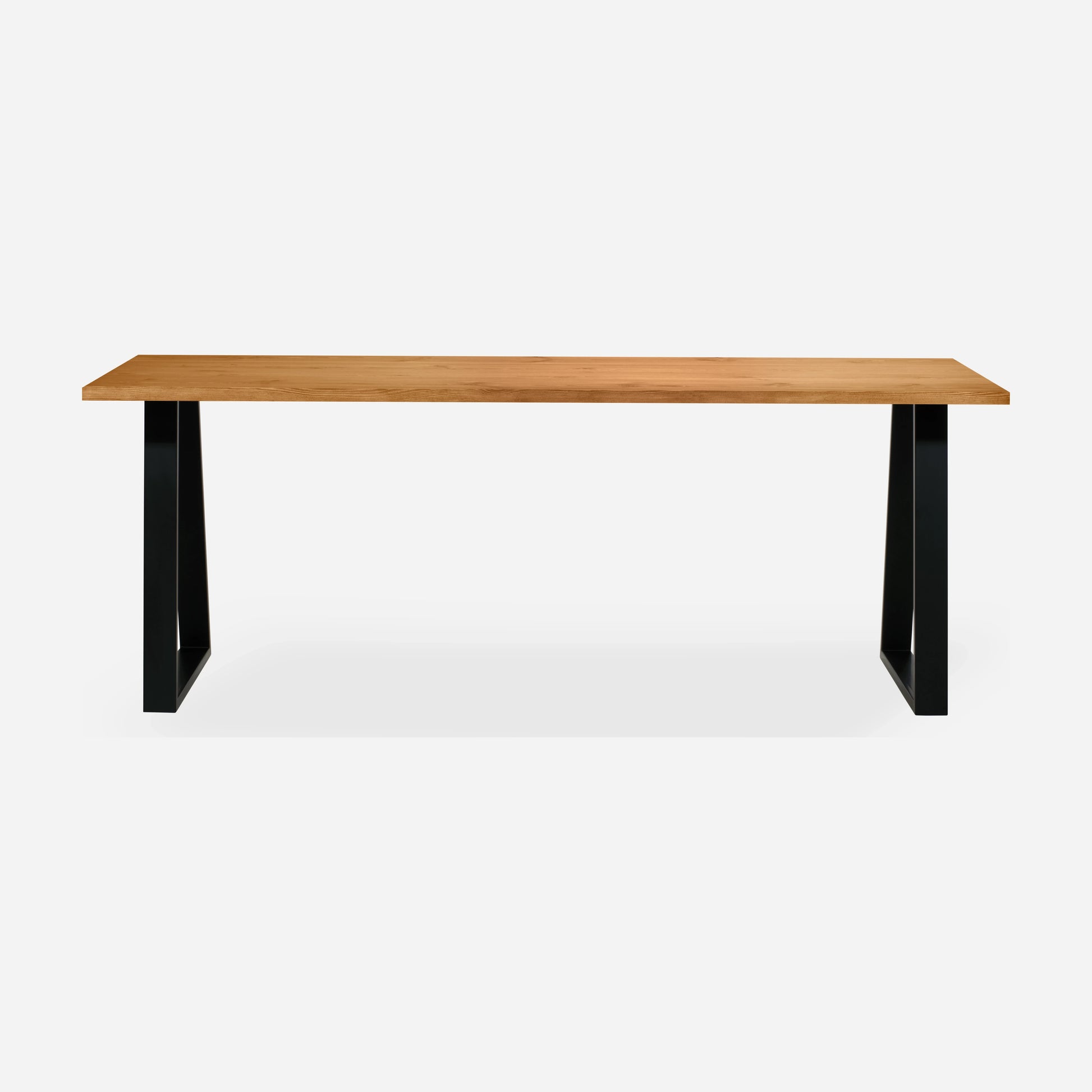 Grove solid wood desk in Cognac with black trapezium legs
