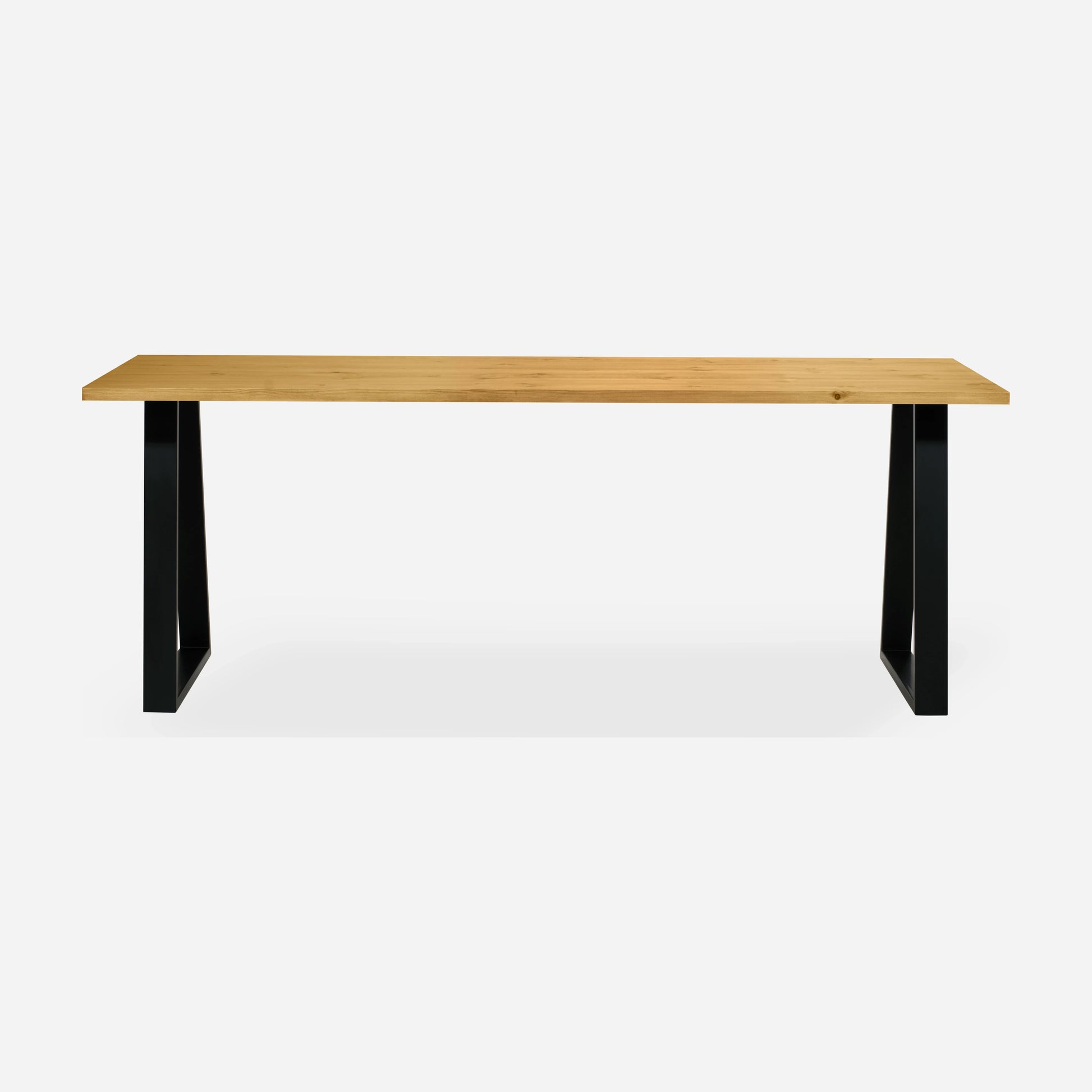 Grove solid wood desk in Honey with black trapezium legs