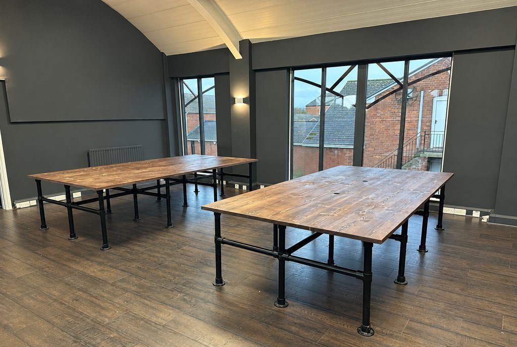 Shared work desks on steel legs in a co-working space